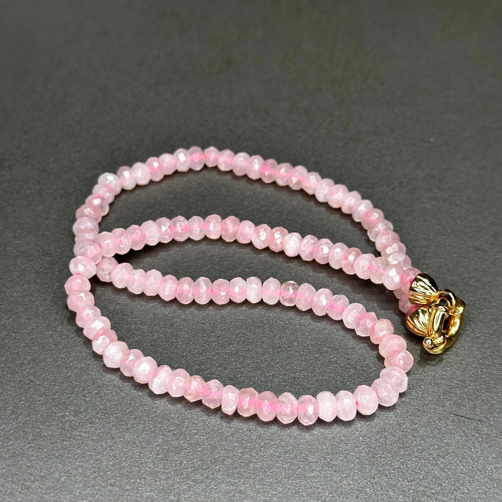 Faceted rose quartz strand with gold clasp
